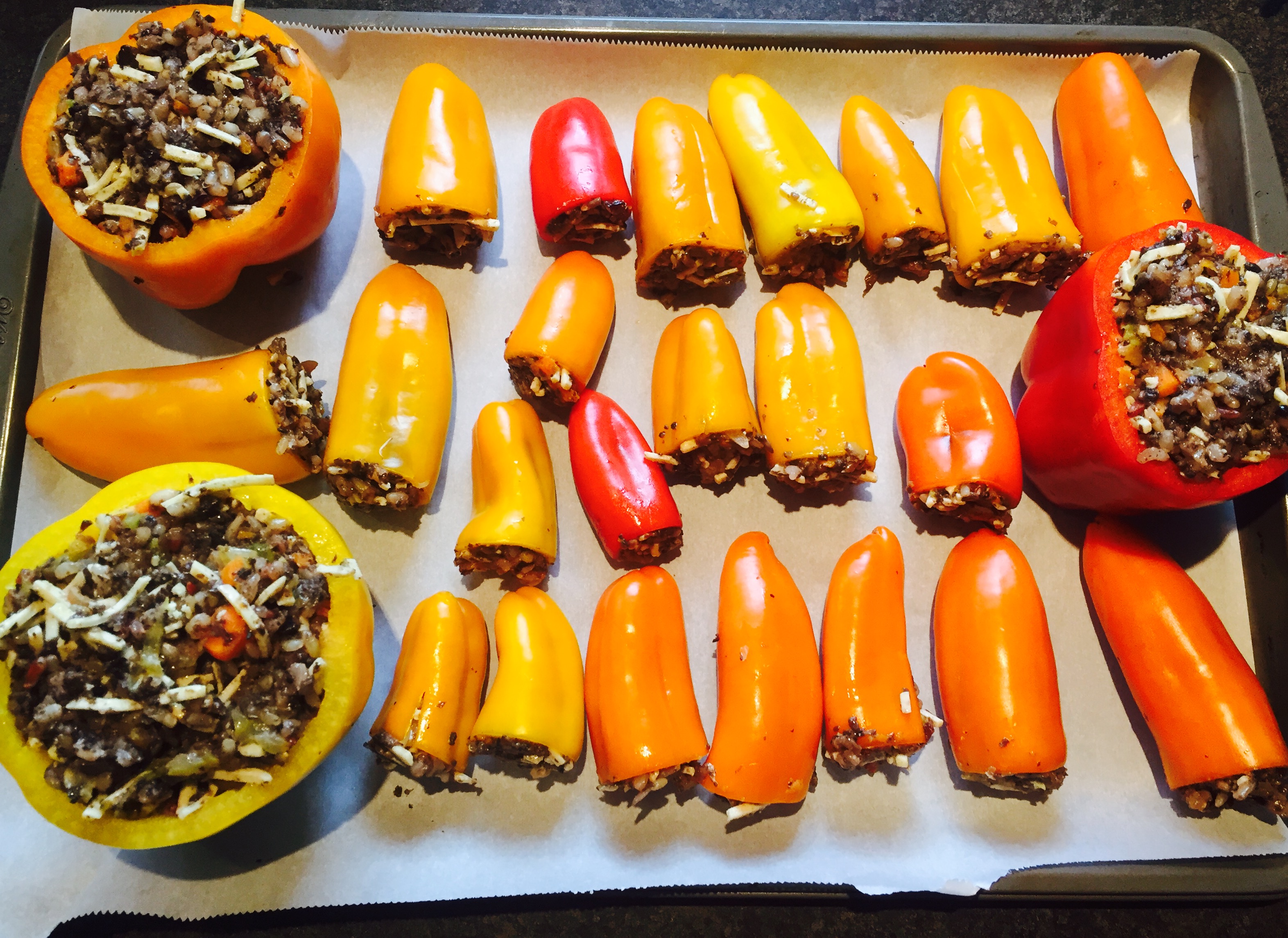 Sweet peppers stuffed with sauteed mushrooms, wild rice, mirepoix and dairy-free cheese