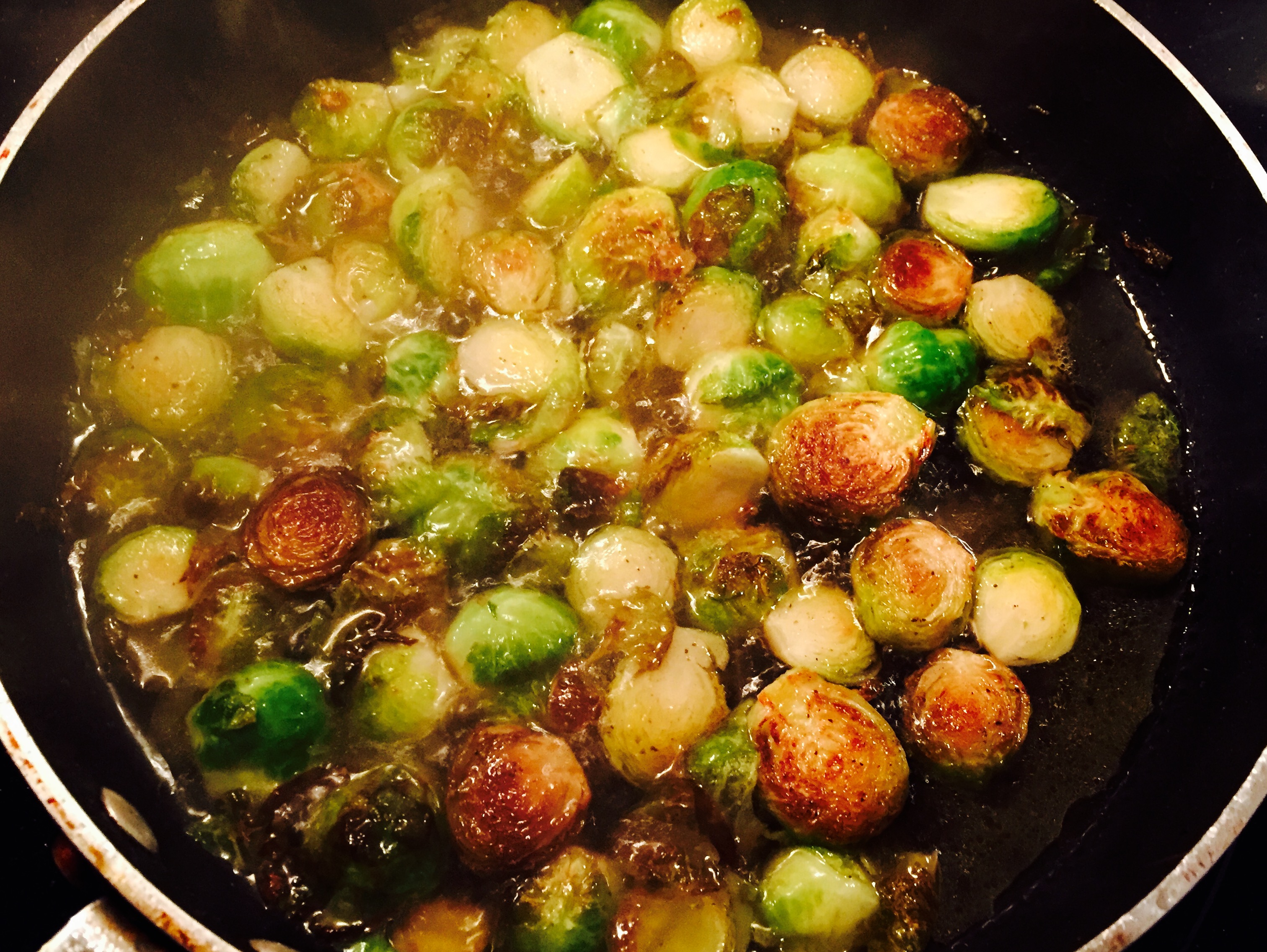 Brussel sprouts simmering after being caramielized into pure deliciousness ... simple and scrumptuous