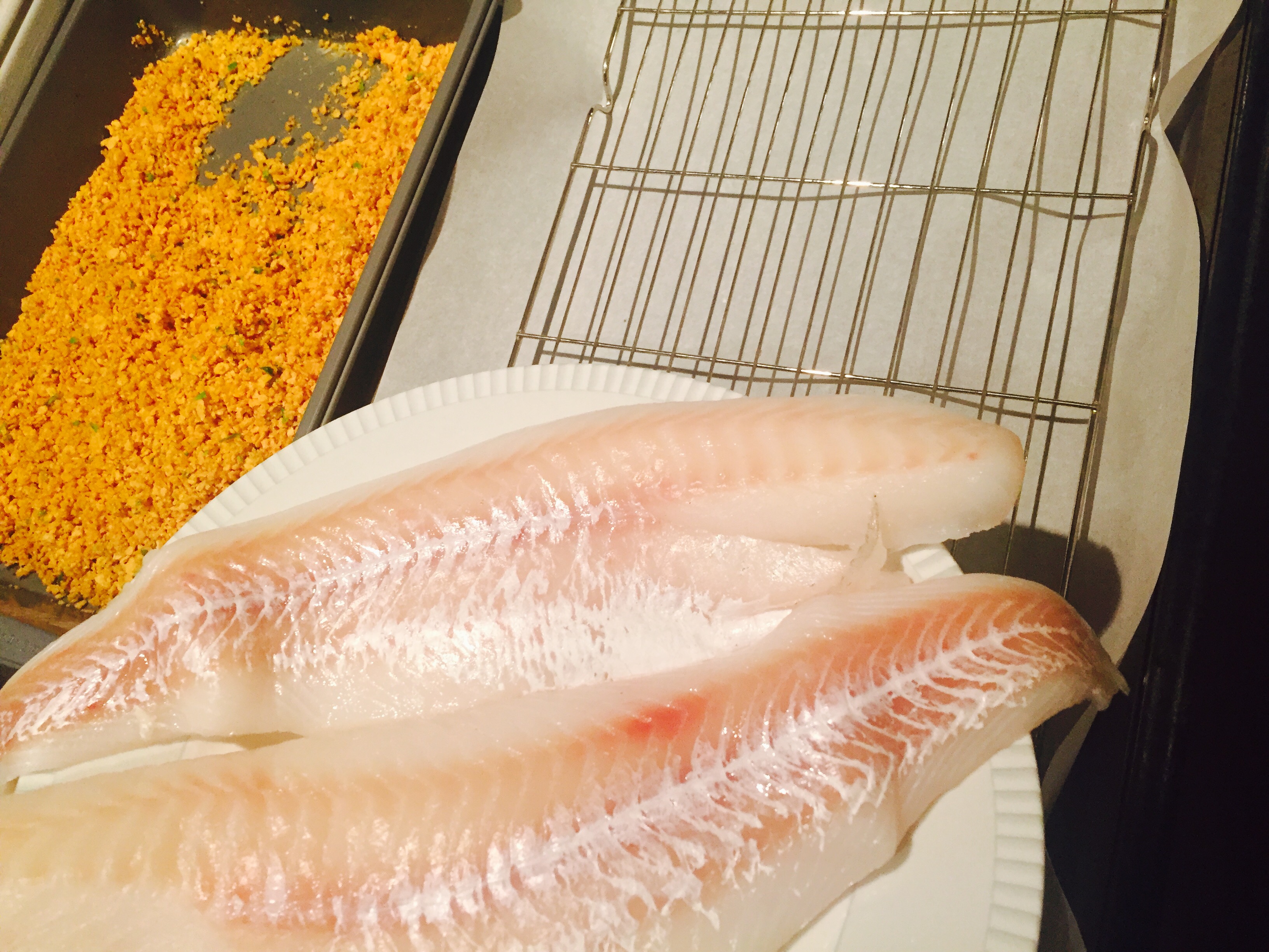 Beautiful fresh cod filets ready to be coated in crispy ground cereal with good olive oil, lemon zest and fresh parsley