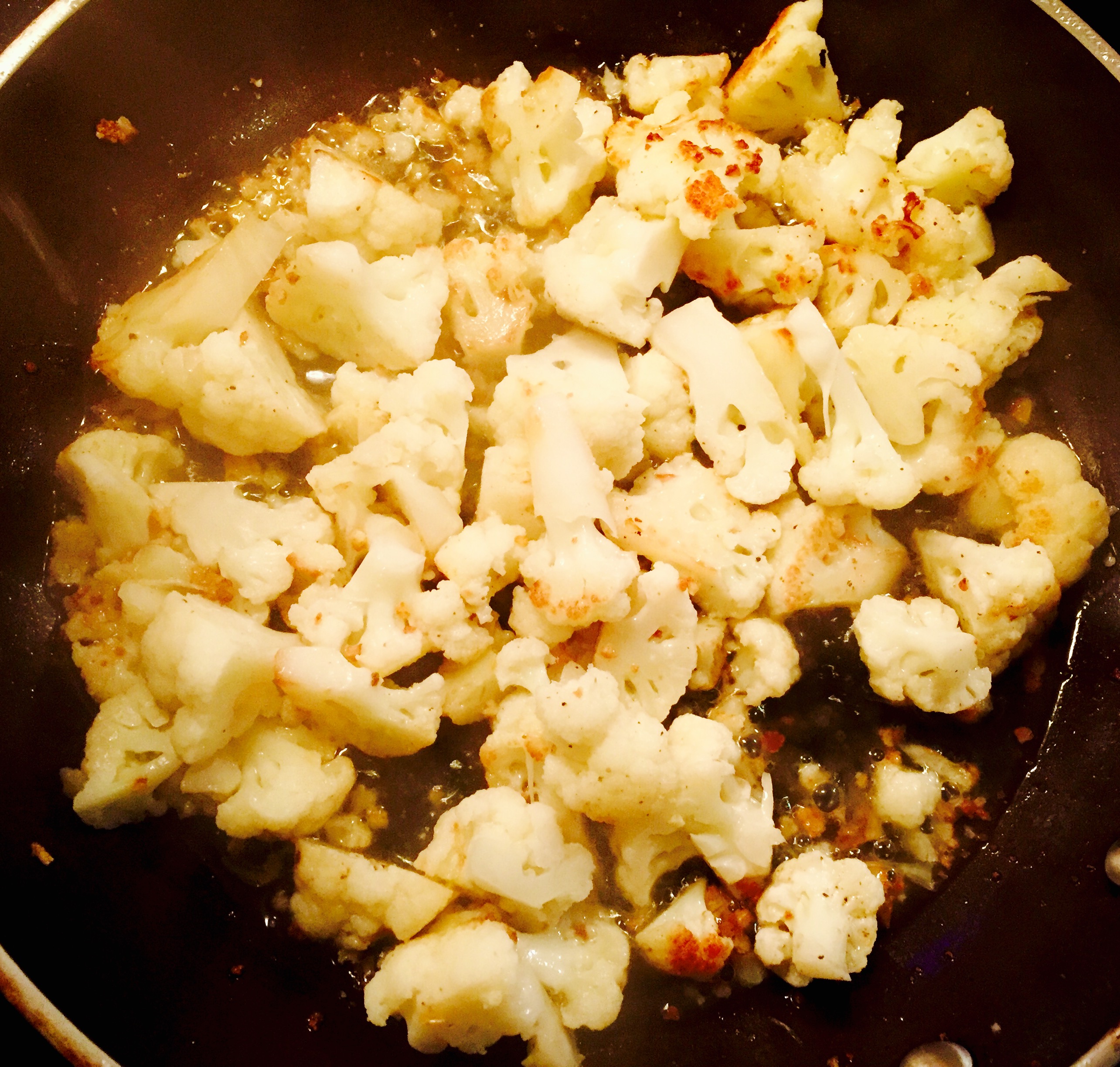 Cauliflower florets sautéing to perfection and almost ready for some white wine