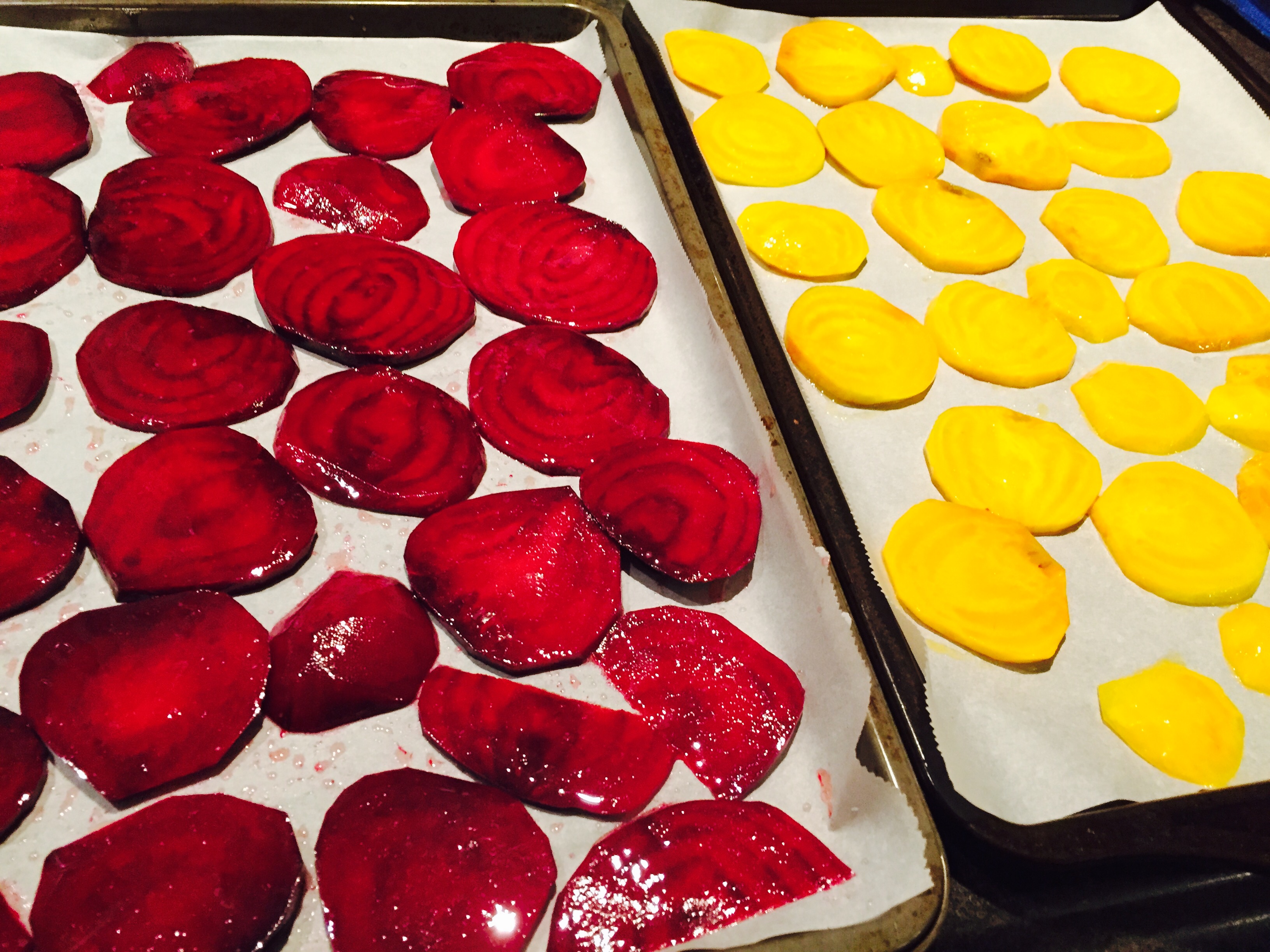 Sliced red beets and yellow beets seasoned and ready for roasting