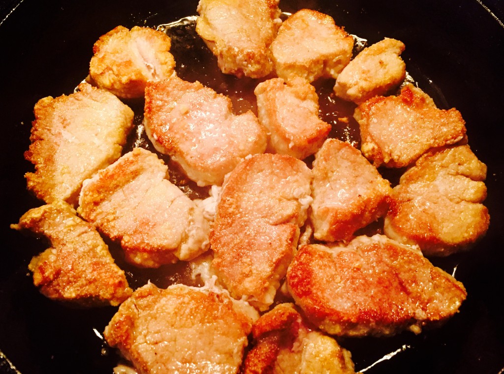 Pork tenderloin dredged in flour browning nicely in a non-stick skillet