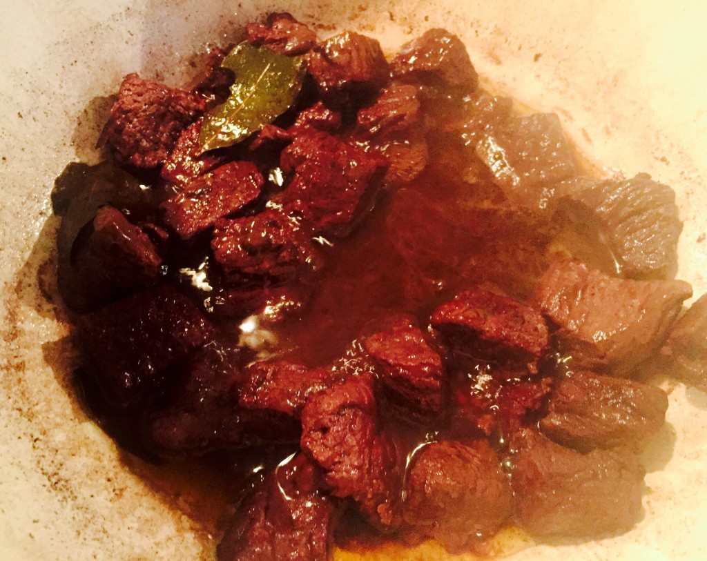 Ridiculously tender organic beef braising in red wine for hours
