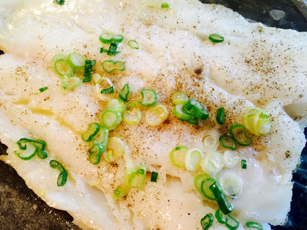 Delicious baked codfish with wilted scallions