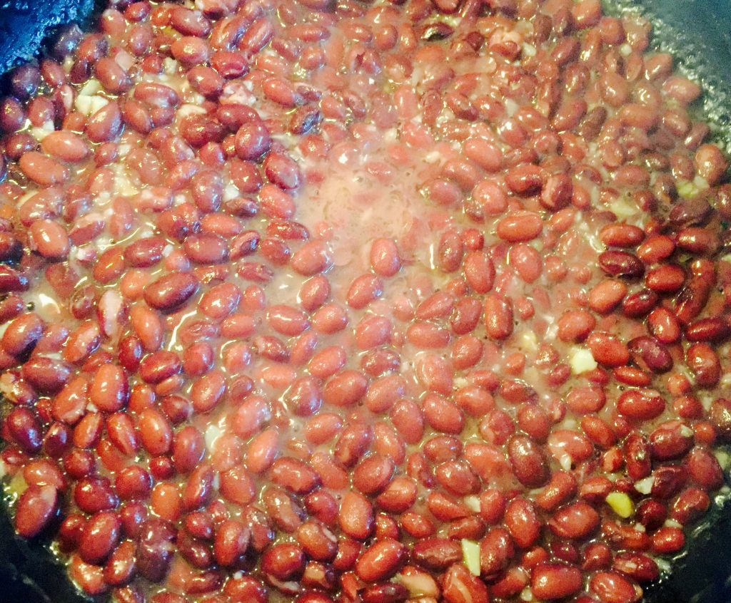 Silky black beans simmering in a savoury sauce