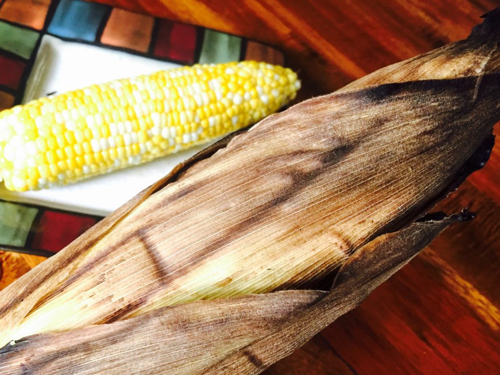 Fresh corn on the cob that's been whole roasted in the husk on the bbq, so delicious