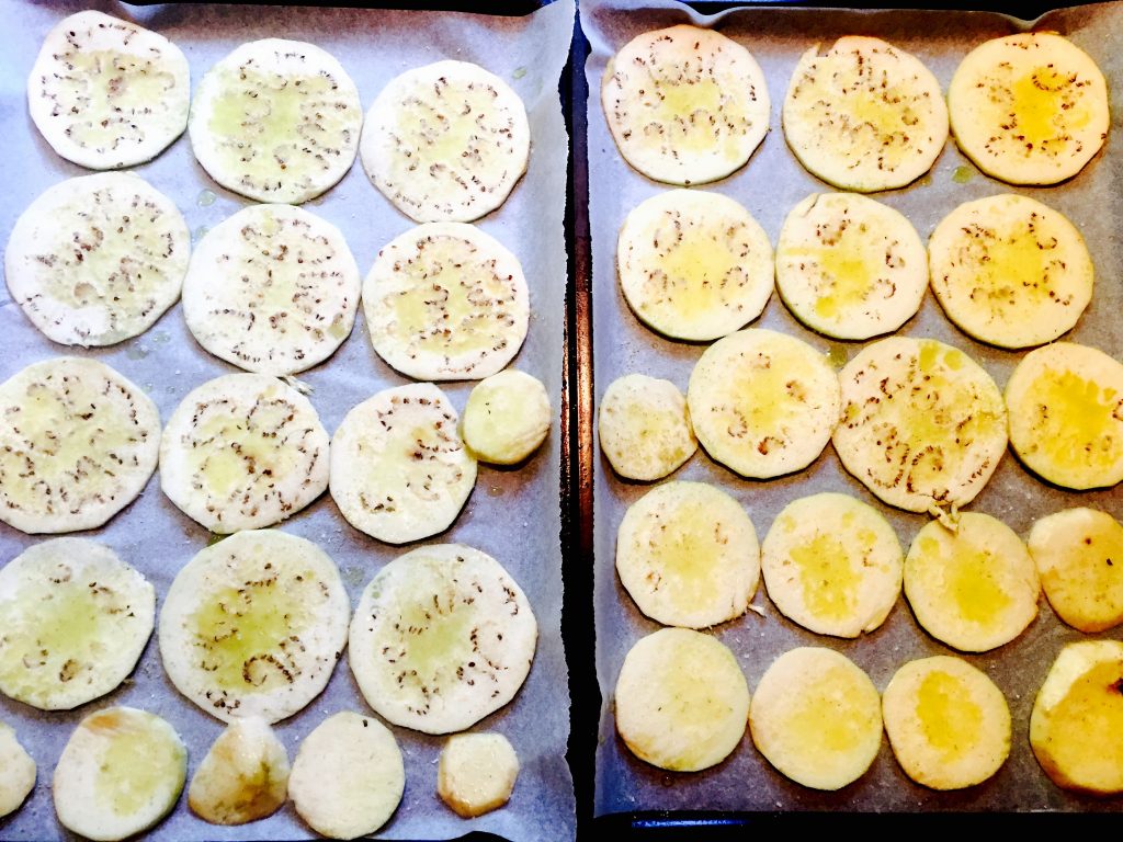 Some thinly sliced eggplant "chips" ready for a quick roast before making an appearance on our pizza pie