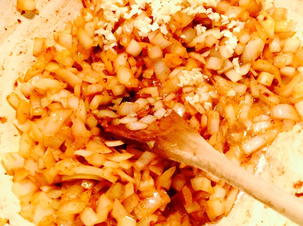 Onions and garlic sauteeing in the deglazed deliciousness