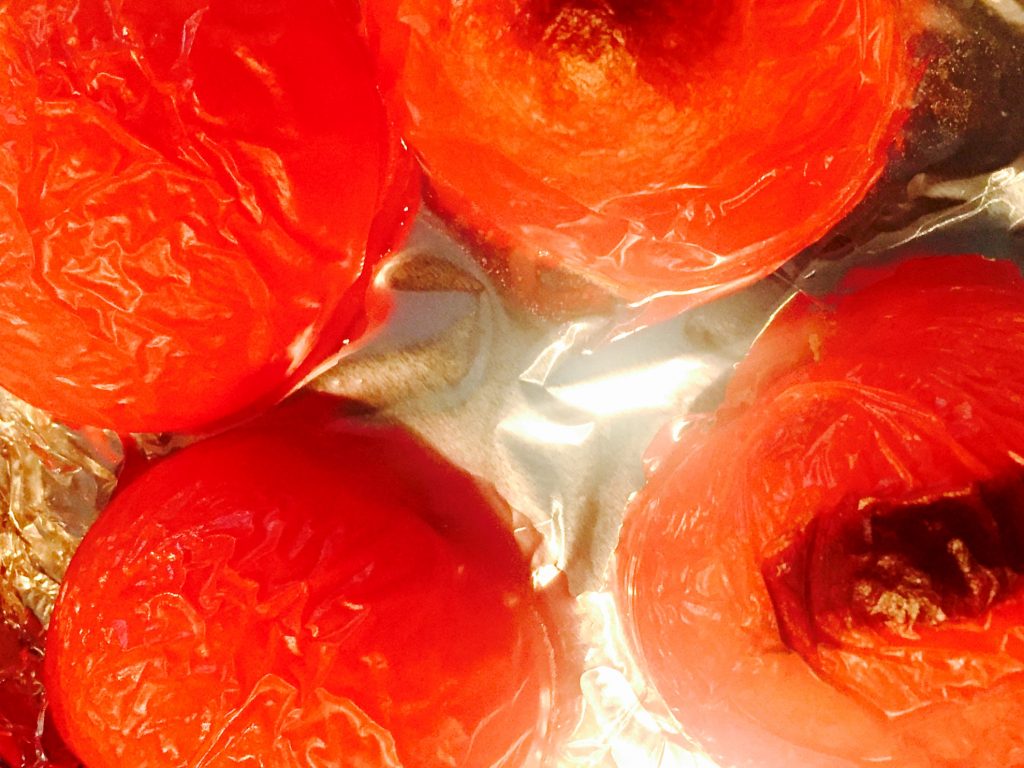 Broiled tomatoes, ready to be peeled