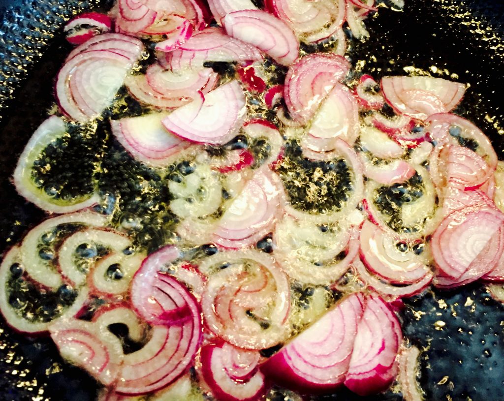 Sliced shallots sauteeing nicely