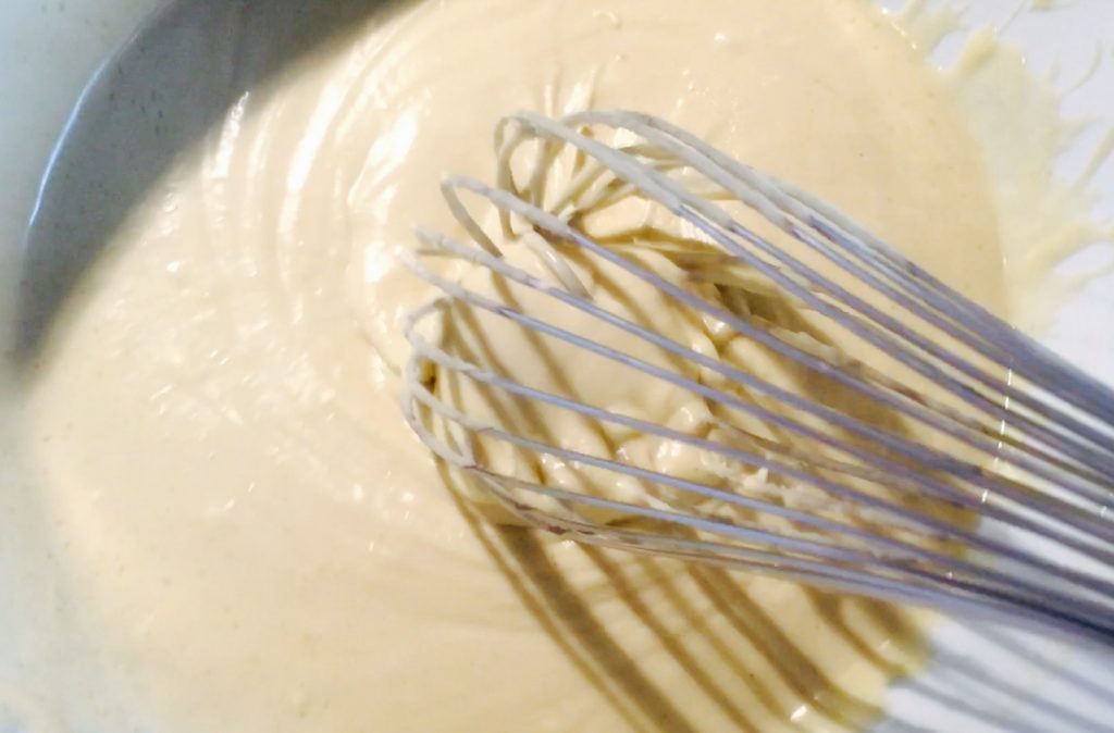 Gluten free pizza dough mixture, thoroughly whisked and ready to be put in pans