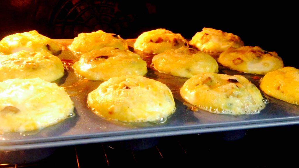 Lovely cheesy egg muffins puffing up nicely in a 350 oven