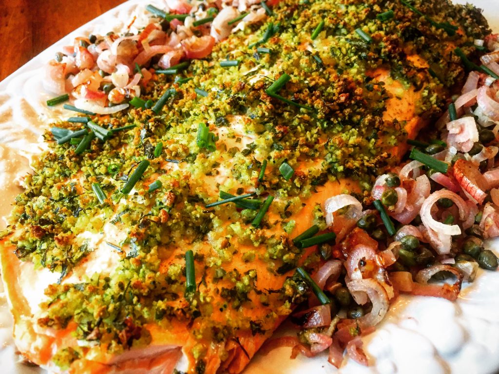 Succulent herb-crusted salmon with perfectly roasted shallots & capers