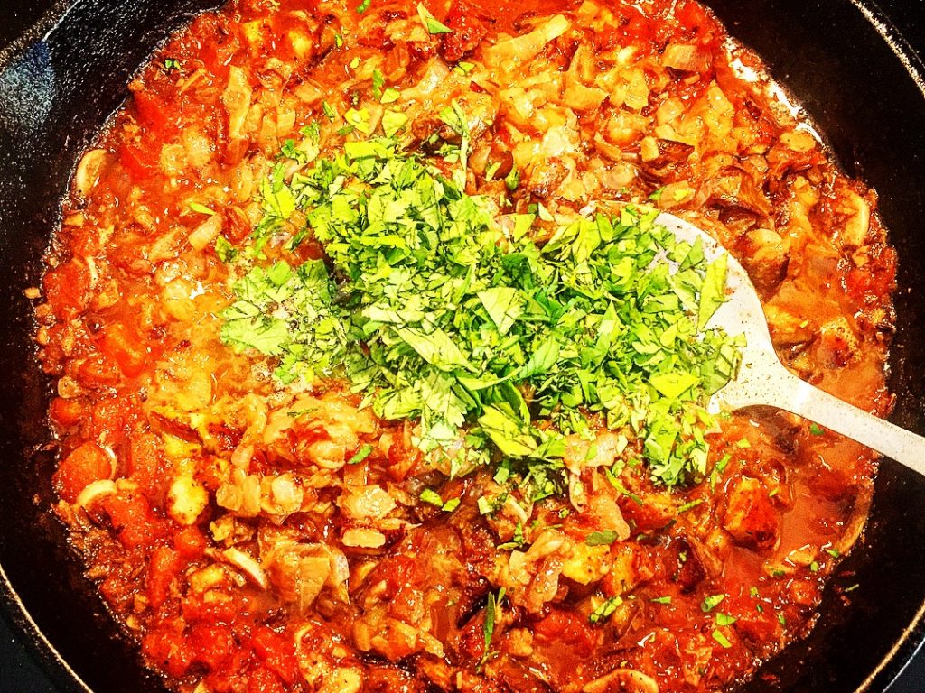 SIlky & delicious homemade baighan bharta simmering gently in a cast iron skillet
