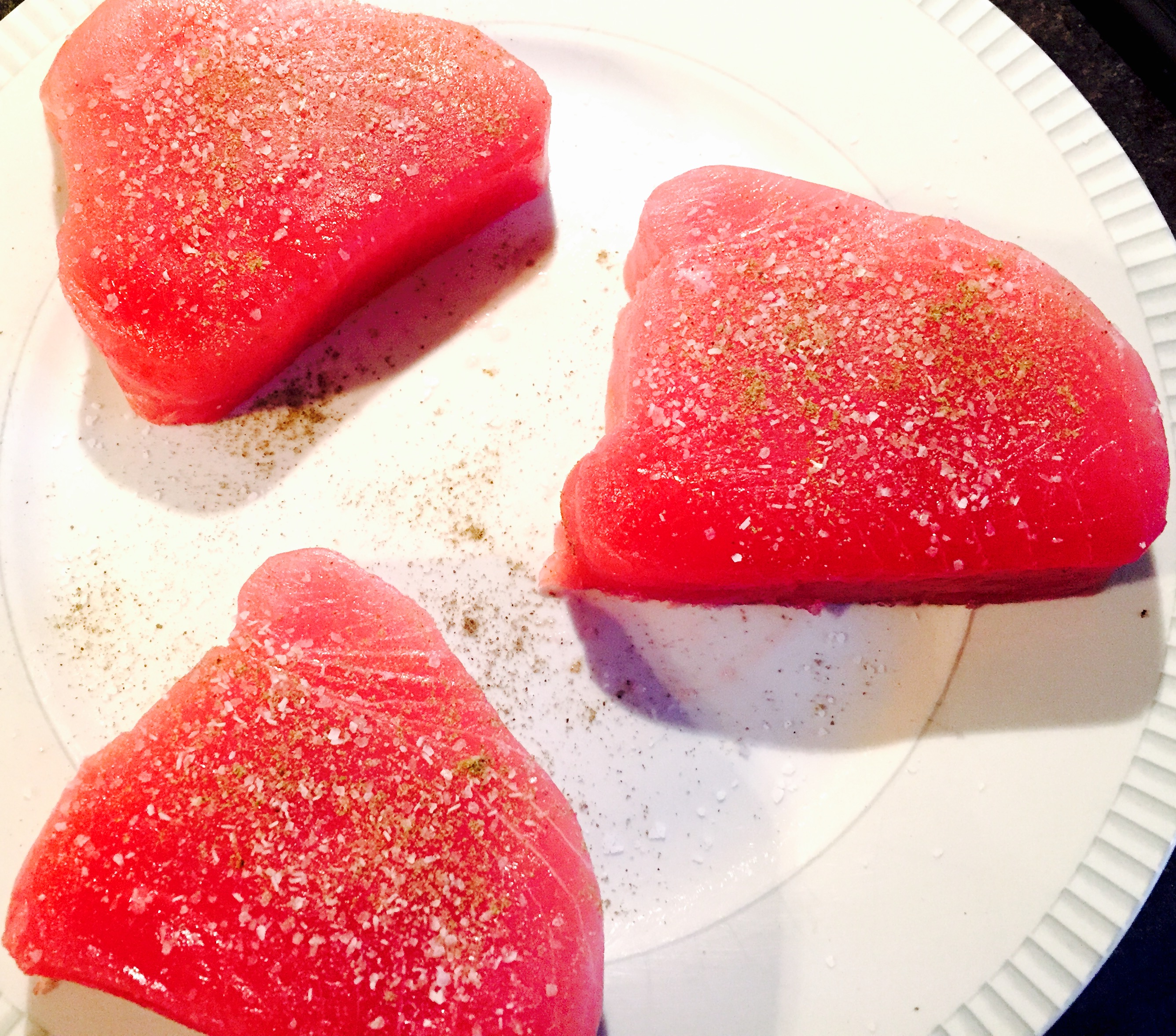 Fresh seasoned tuna steaks ready to be seared