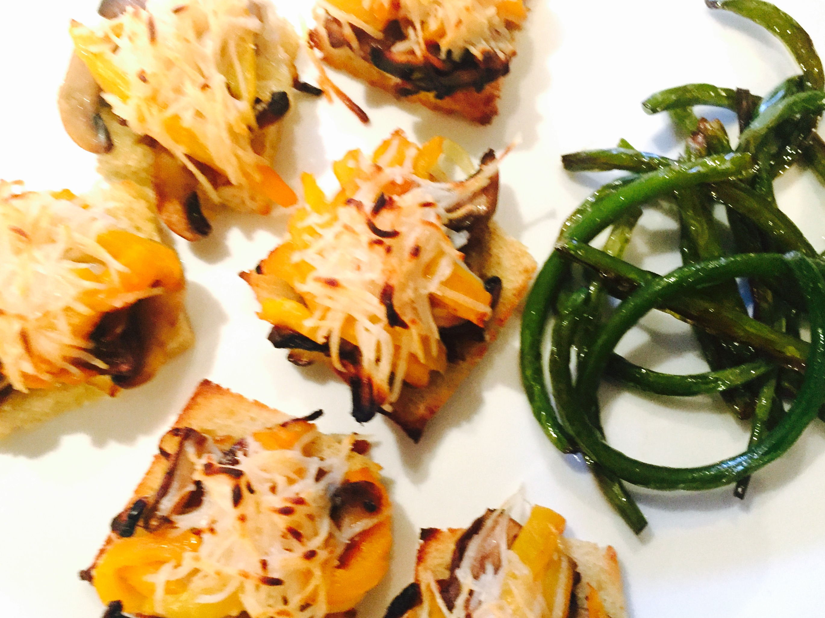 Mushrooms, roasted peppers and onions au gratin on gluten free toast with sauteed garlic scapes