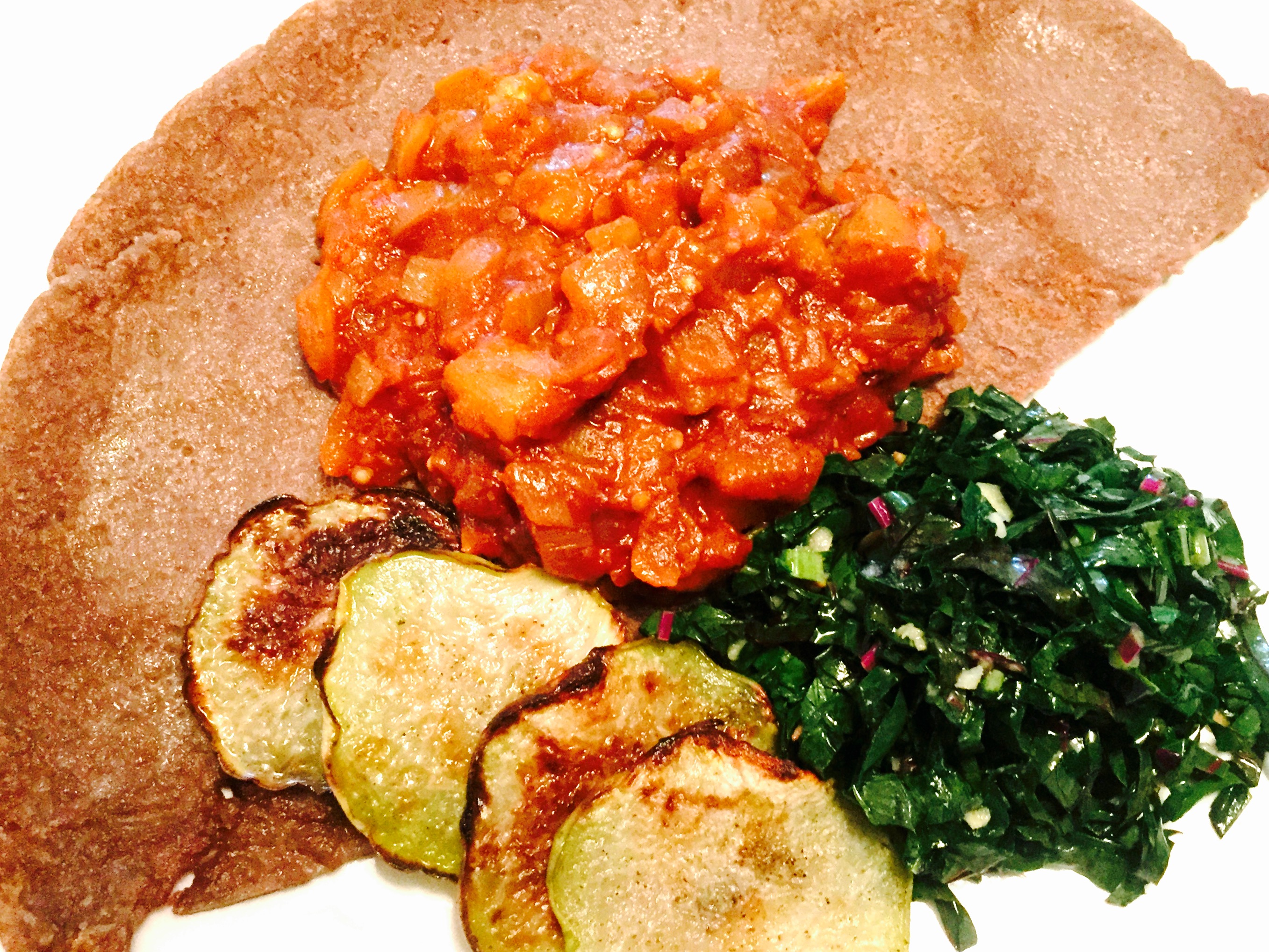 Ethiopian eggplant wot on home-made injera with roasted kohlrabi chips and fresh salad made from the kohlrabi greens