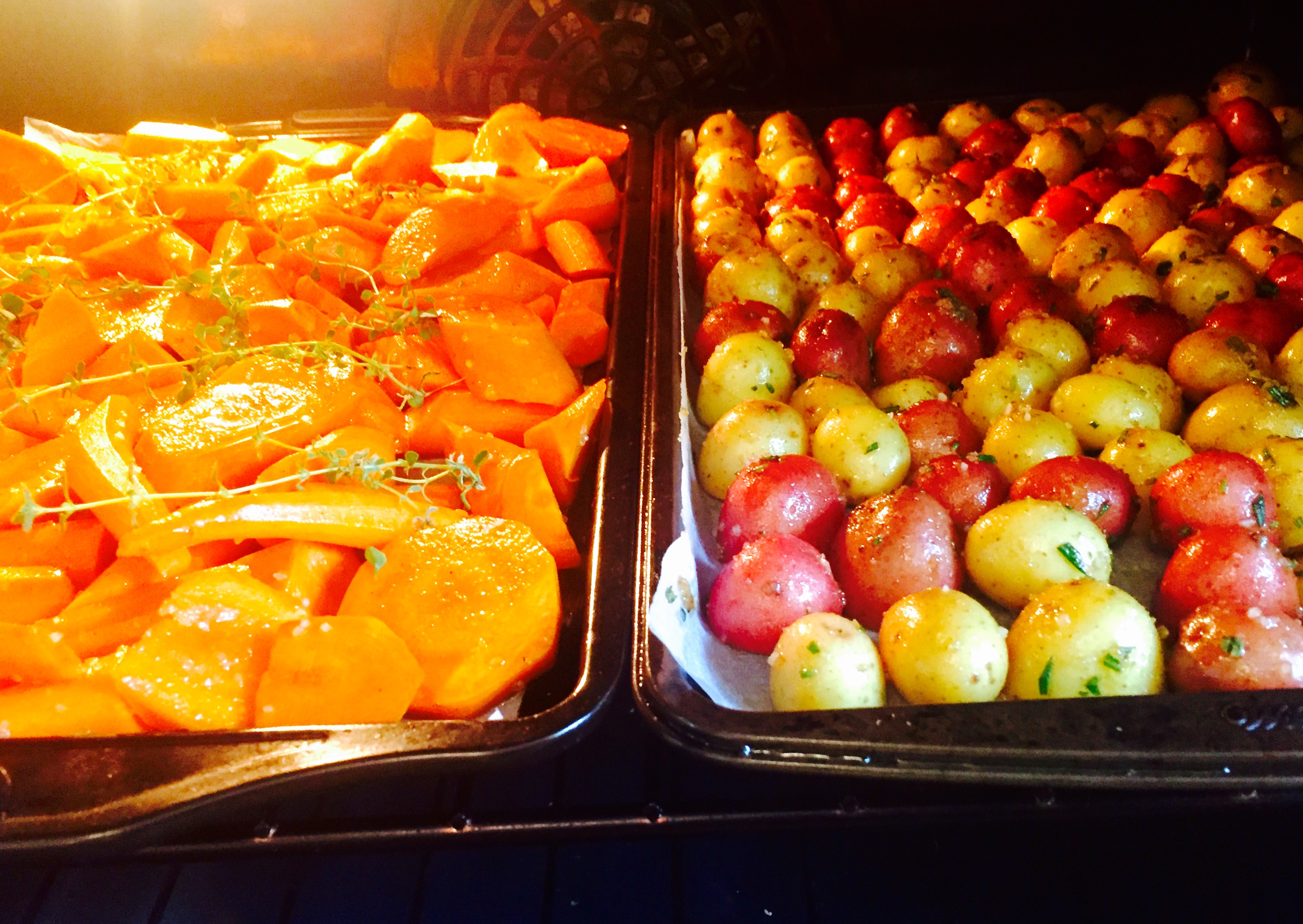Herbed new potatoes & maple-glazed carrots roasting nicely in a 400° oven